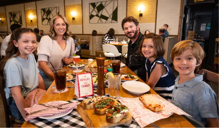 People toasting pizza